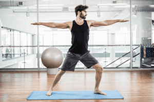 Gym-fit guy performing yoga posture