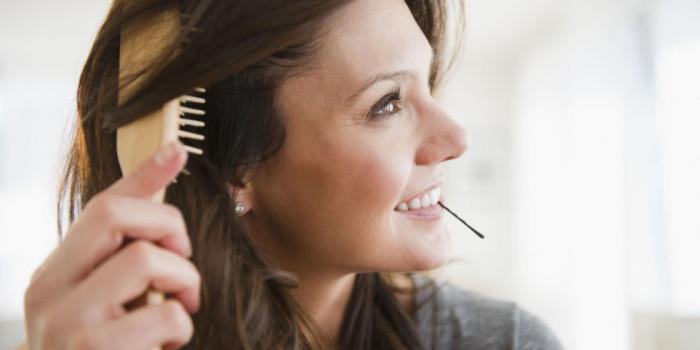 Woman brushing frizzy hair