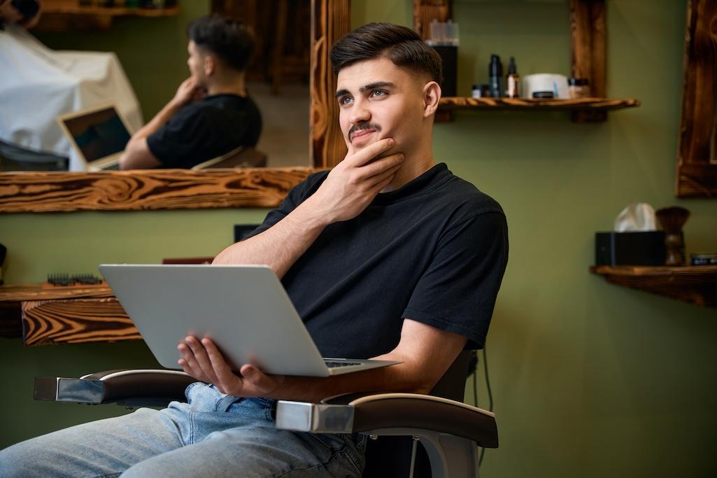 man-hairdresser-using-laptop-for-work-browsing-new-2025-03-05-11-07-39-utc.jpg