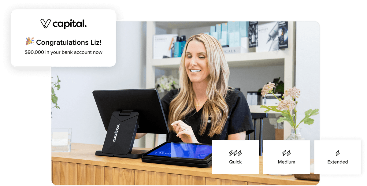 Business owner on POS device smiling because she just received funding for her business