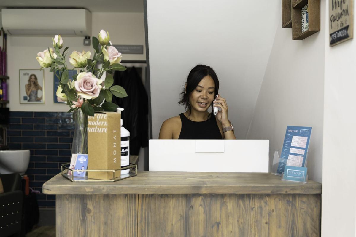 Woman answering phone to provide customer service