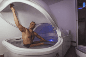 Man about to lay down in a flotation pod for a salt float