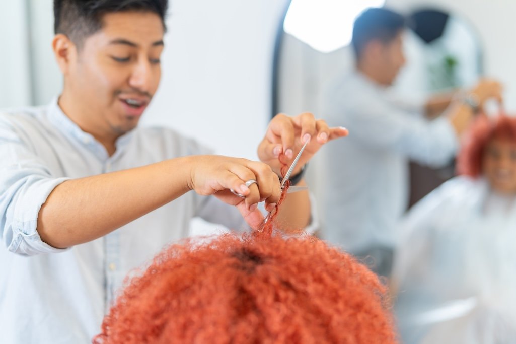 hairdresser-combing-the-curly-hair-of-a-woman-2025-03-09-06-26-52-utc.jpg