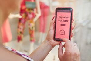 smartphone with buy now pay later prompt on screen